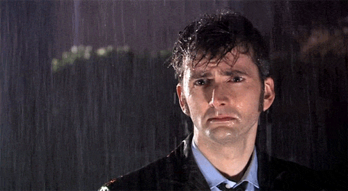 GIF of David Tennant (as Dr. Who) standing in the rain, looking soulful.