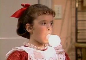 Vicki, the robot girl from Small Wonder, has a lightbulb in her mouth.